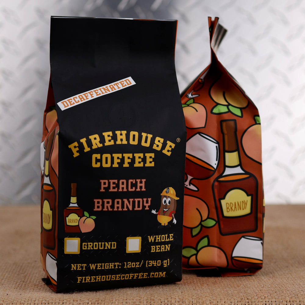 Firehouse Coffee Decaf Peach Brandy Flavored Coffee in a 12 oz bag, crafted with Swiss Water Process decaffeinated coffee and infused with the sweet flavor of ripe peaches and smooth brandy. Fresh roasted and available in whole bean or ground with firefighter-themed packaging.