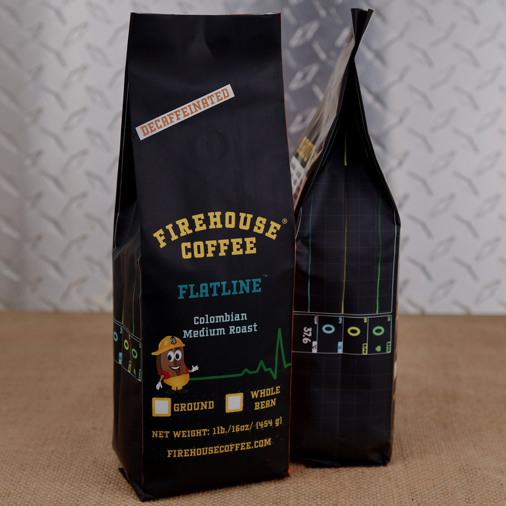 Firehouse Coffee Flatline decaf Colombian medium roast coffee in a 1 lb bag with heart monitor graphics and a firefighter bean character.