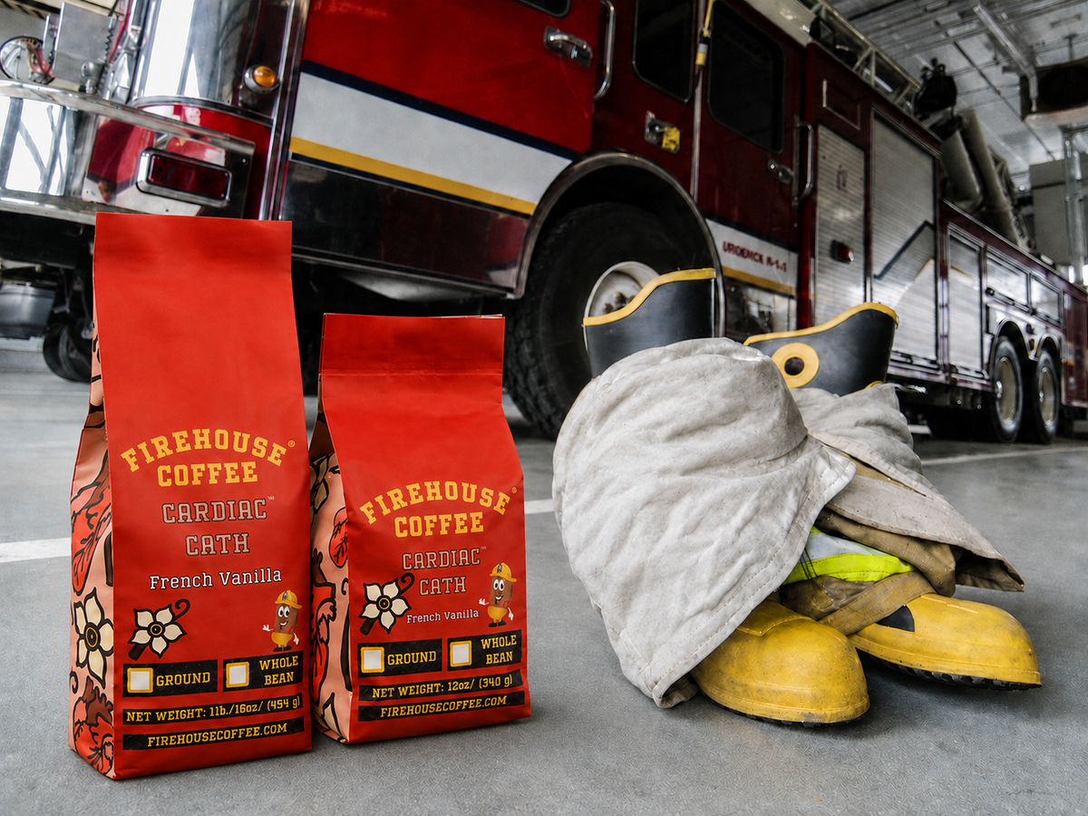 Two Firehouse Coffee Cardiac Cath French Vanilla coffee bags beside firefighter turnout gear and a red fire engine.
