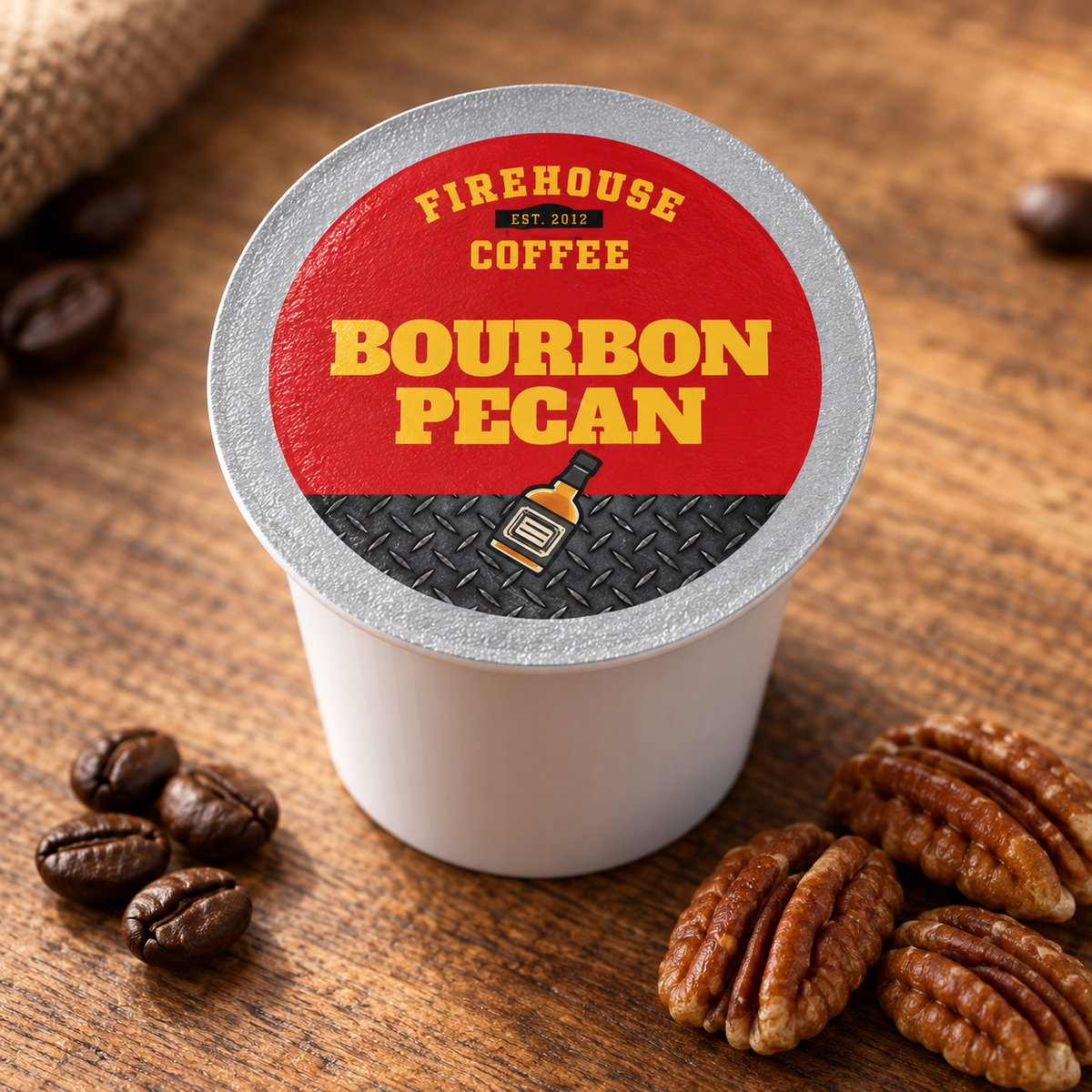 Firehouse Coffee Bourbon Pecan K-Cup with a red and silver lid beside roasted coffee beans and pecans.
