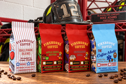 Four Firehouse Coffee bags displayed in front of Mike Adams’s number 12 firefighter helmet and red firehouse gear rack.