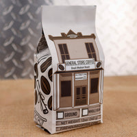 General Store Coffee Brazil Medium Roast by Firehouse Coffee featuring artwork of the historic General Store and Post Office that now houses the Firehouse Coffee roastery