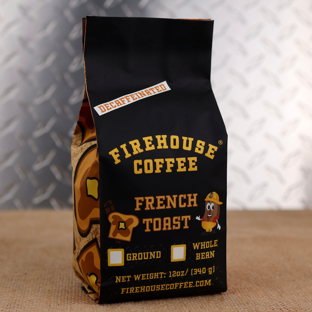 Firehouse Coffee French Toast Decaffeinated flavored coffee in a 12 oz bag, featuring the warm taste of buttery French toast, cinnamon, maple syrup, and vanilla. Swiss Water Process decaf coffee available in ground or whole bean with firefighter-themed packaging.