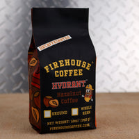 12oz bag of Firehouse Coffee Decaf Hazelnut Coffee featuring premium Swiss Water Process decaf coffee with smooth roasted hazelnut flavor made from 100% Arabica beans.