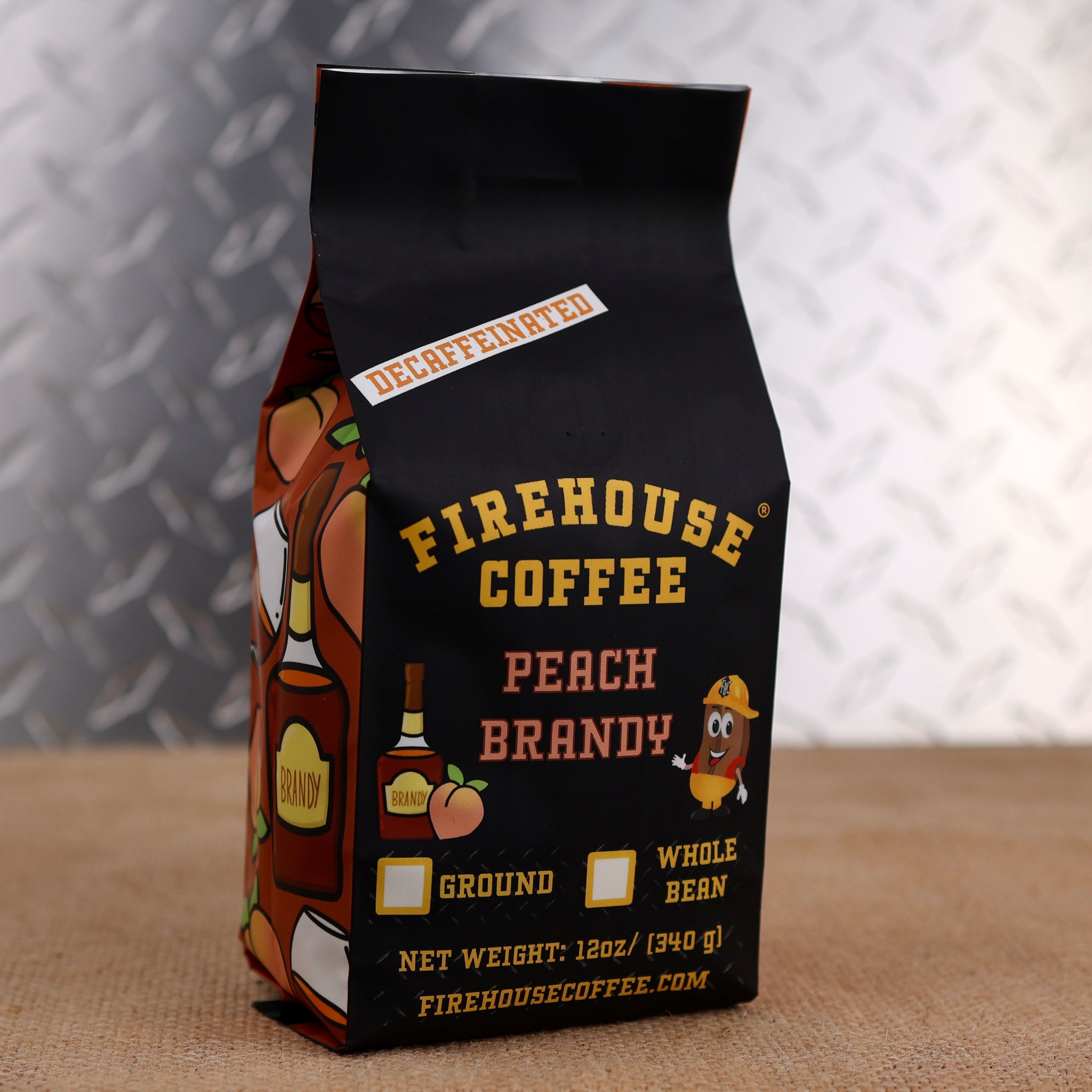 12 oz bag of Firehouse Coffee Decaf Peach Brandy Coffee, featuring premium Swiss Water Process decaf coffee with juicy peach flavor and rich brandy notes. Fresh roasted, available in whole bean or ground.