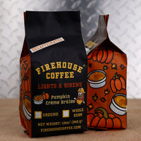 12 oz bag of Firehouse Coffee Lights & Sirens Pumpkin Crème Brûlée Decaf coffee with colorful autumn-themed packaging. Swiss Water Process decaffeinated flavored coffee blending pumpkin spice with smooth, creamy crème brûlée notes, available whole bean or ground.