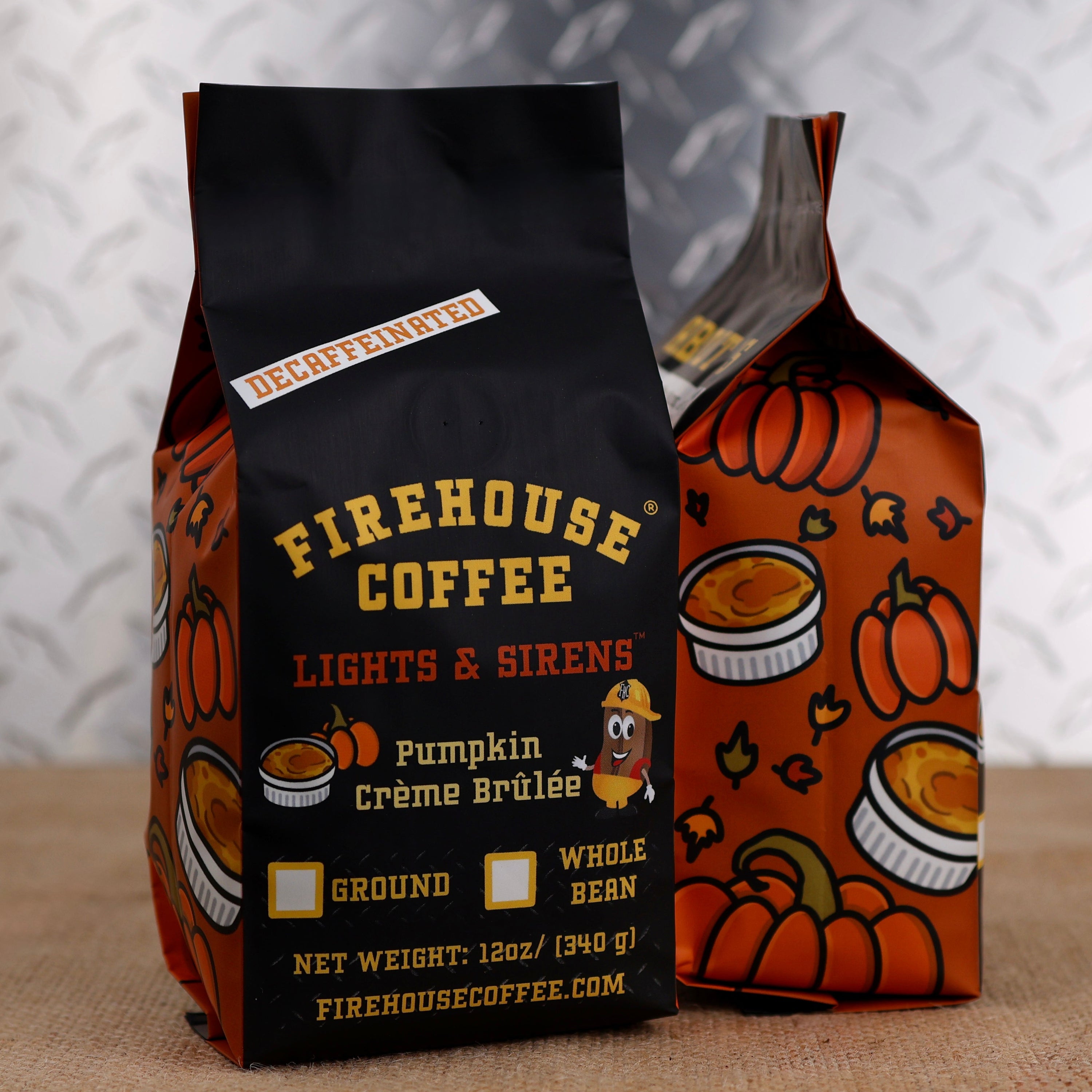 12 oz bag of Firehouse Coffee Lights & Sirens Pumpkin Crème Brûlée Decaf coffee with colorful autumn-themed packaging. Swiss Water Process decaffeinated flavored coffee blending pumpkin spice with smooth, creamy crème brûlée notes, available whole bean or ground.