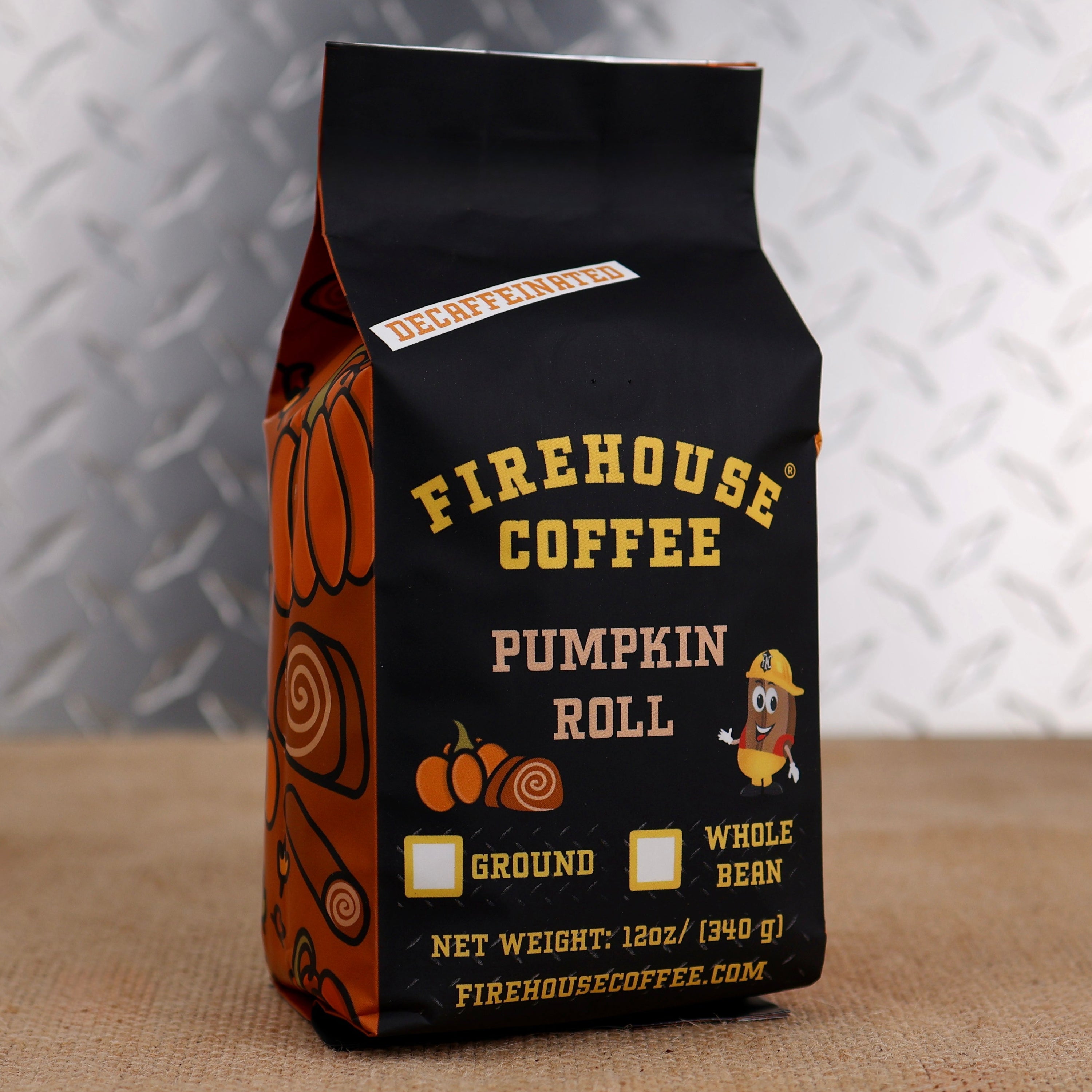 Firehouse Coffee Pumpkin Roll Decaf flavored coffee, 12oz premium Arabica coffee in a fall-themed bag with pumpkin roll, cinnamon, and vanilla flavors, naturally decaffeinated using the Swiss Water Process for a smooth, full-bodied cup.