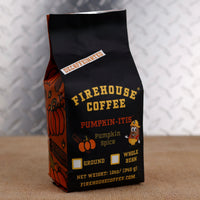Firehouse Coffee Pumpkin-Itis Decaffeinated Pumpkin Spice flavored coffee in a 12 oz bag with festive pumpkin artwork. Swiss Water Process decaf coffee available ground or whole bean, delivering warm pumpkin spice flavor in a smooth medium roast.