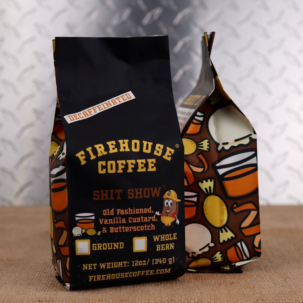 12 oz bag of Firehouse Coffee Shit Show Decaffeinated Coffee, a Swiss Water Process decaf flavored with Old Fashioned Whiskey, creamy Vanilla Custard, and rich Butterscotch. Bold firefighter-themed coffee packaging for premium flavored coffee lovers.