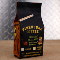 12oz bag of Firehouse Coffee Decaf Hazmat Hazelnut flavored coffee featuring cinnamon hazelnut flavor, Swiss Water Process decaf coffee with rich roasted hazelnut and cinnamon spice notes.