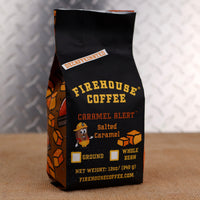 12 oz bag of Firehouse Coffee Caramel Alert Decaf Salted Caramel Coffee, featuring smooth Swiss Water Process decaf beans infused with sweet buttery caramel and a hint of sea salt. Premium flavored coffee available ground or whole bean.