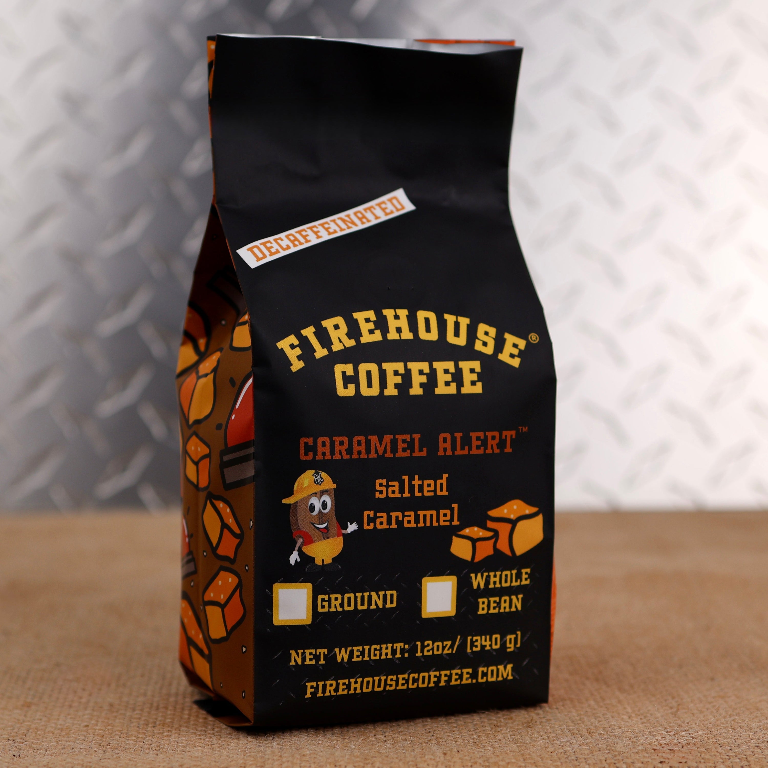 12 oz bag of Firehouse Coffee Caramel Alert Decaf Salted Caramel Coffee, featuring smooth Swiss Water Process decaf beans infused with sweet buttery caramel and a hint of sea salt. Premium flavored coffee available ground or whole bean.