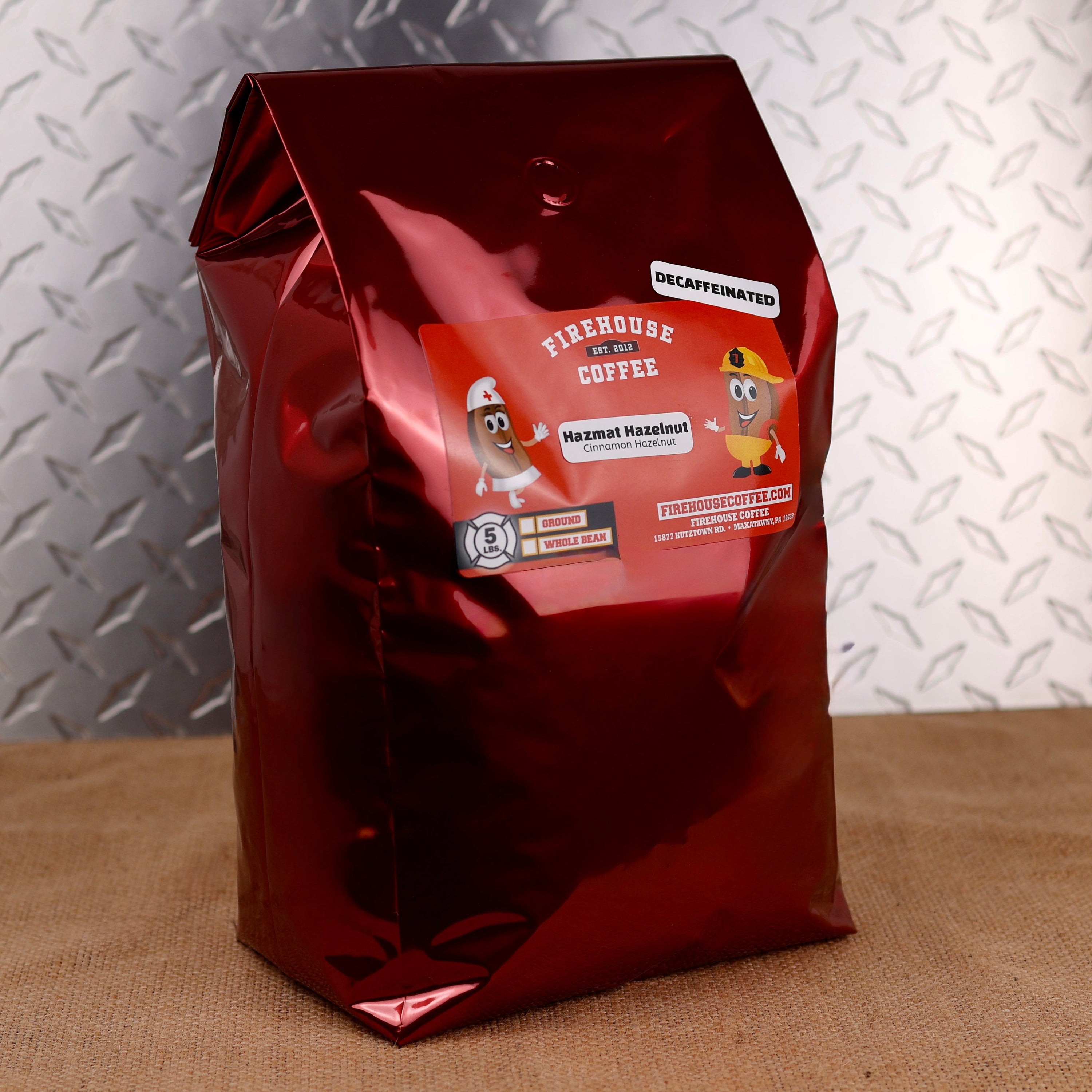 5lb bag of Firehouse Coffee Decaf Hazmat Hazelnut coffee made with premium 100% Arabica beans, naturally decaffeinated using the Swiss Water Process, offering smooth roasted hazelnut and cinnamon flavors in every cup.