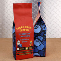Firehouse Coffee Blueberry Explosion Blueberry Cream flavored coffee in a 1 lb bag, available in ground or whole bean, featuring a bold blueberry-themed package design.