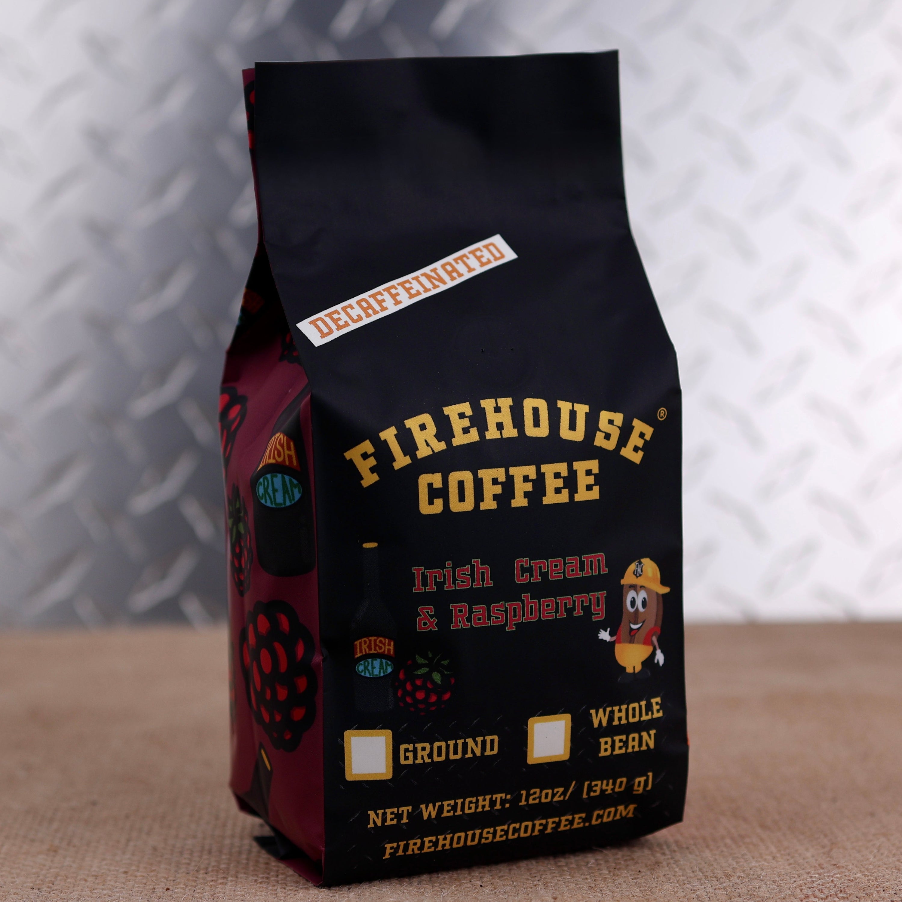A bag of Firehouse Coffee Irish Cream & Raspberry decaffeinated whole bean coffee, standing on a burlap surface against a diamond plate metal background.