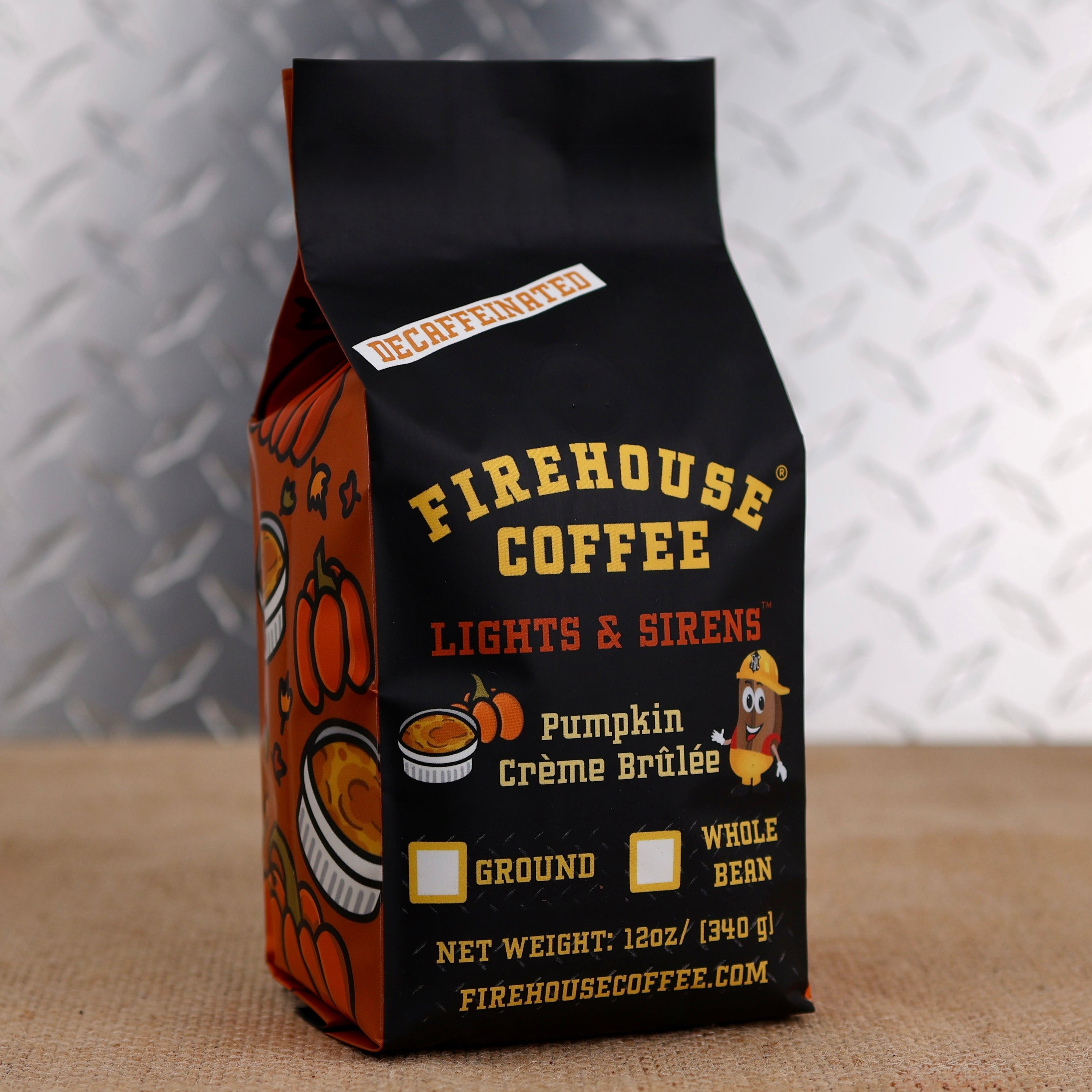 Firehouse Coffee Lights & Sirens Decaffeinated Pumpkin Crème Brûlée flavored coffee in a 12 oz bag featuring festive fall pumpkin artwork. Swiss Water Process decaf coffee with rich pumpkin, caramelized sugar, and creamy crème brûlée flavor, available ground or whole bean.