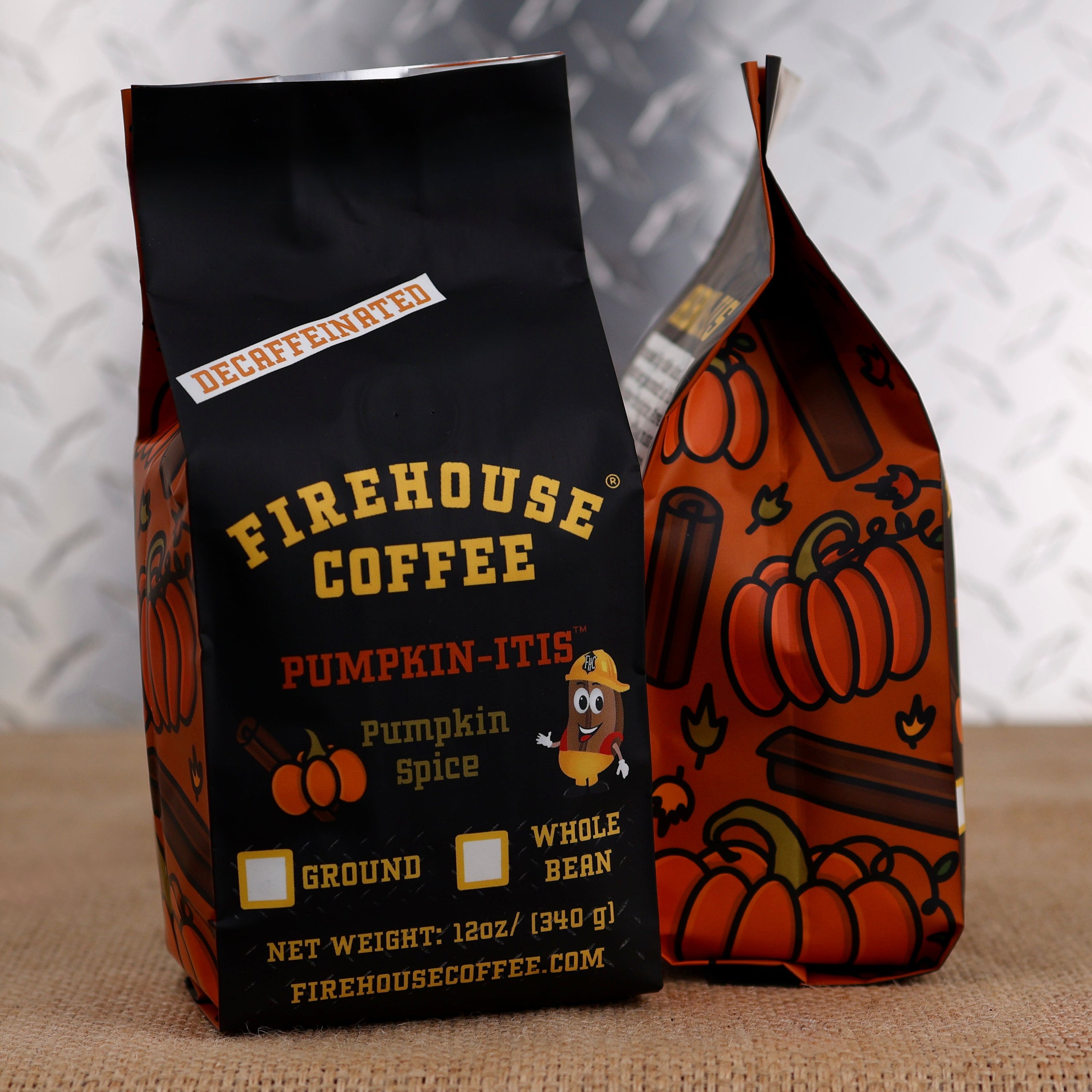 Firehouse Coffee Decaffeinated Pumpkin-Itis Pumpkin Spice coffee in seasonal fall-themed packaging. Premium Swiss Water Process decaf flavored coffee with classic pumpkin spice taste, available in whole bean or ground for fresh brewing