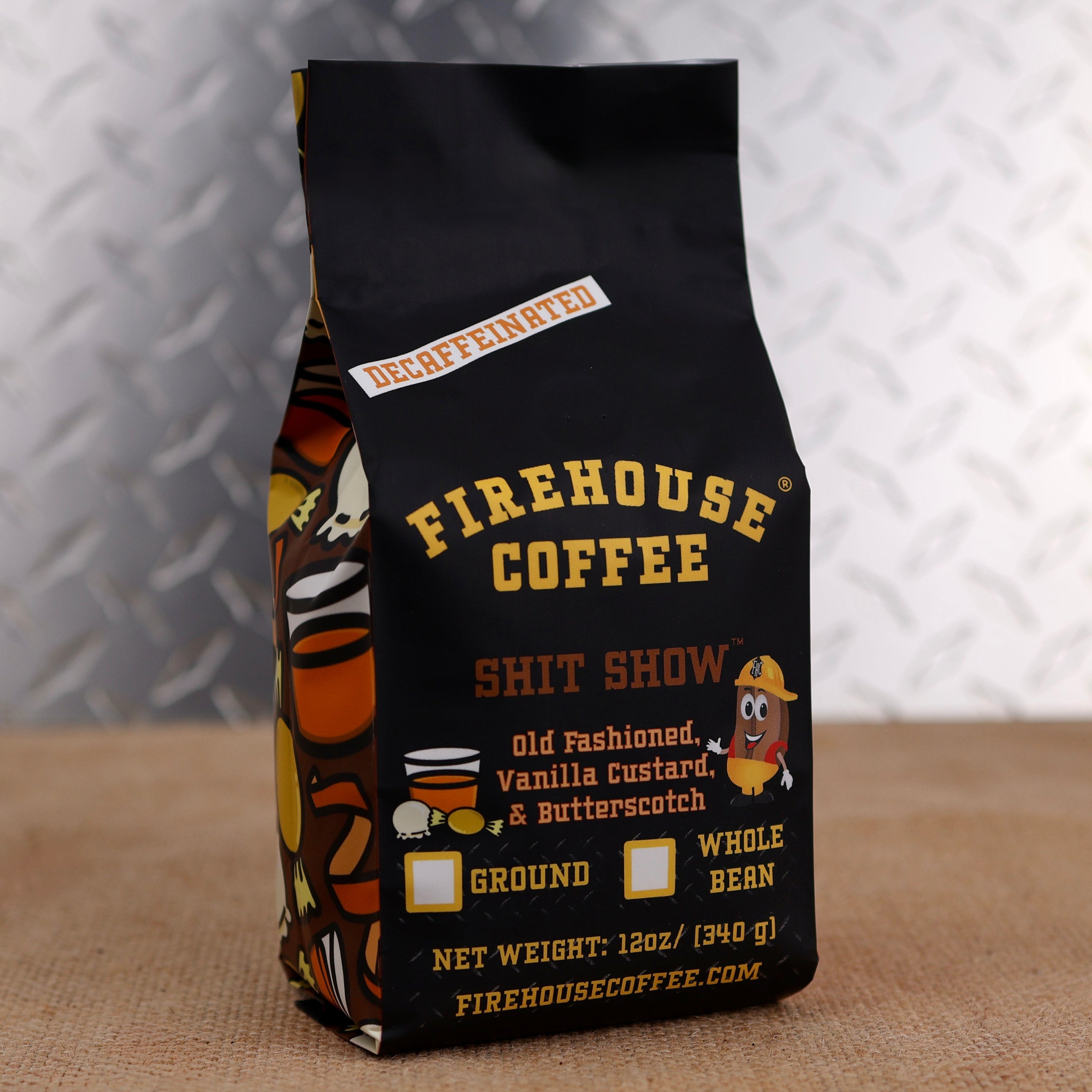 Firehouse Coffee Shit Show decaffeinated flavored coffee in a 12 oz bag featuring Old Fashioned Whiskey, Vanilla Custard, and Butterscotch flavors. Swiss Water Process decaf coffee with Firehouse Coffee's signature firefighter-themed packaging, available ground or whole bean.