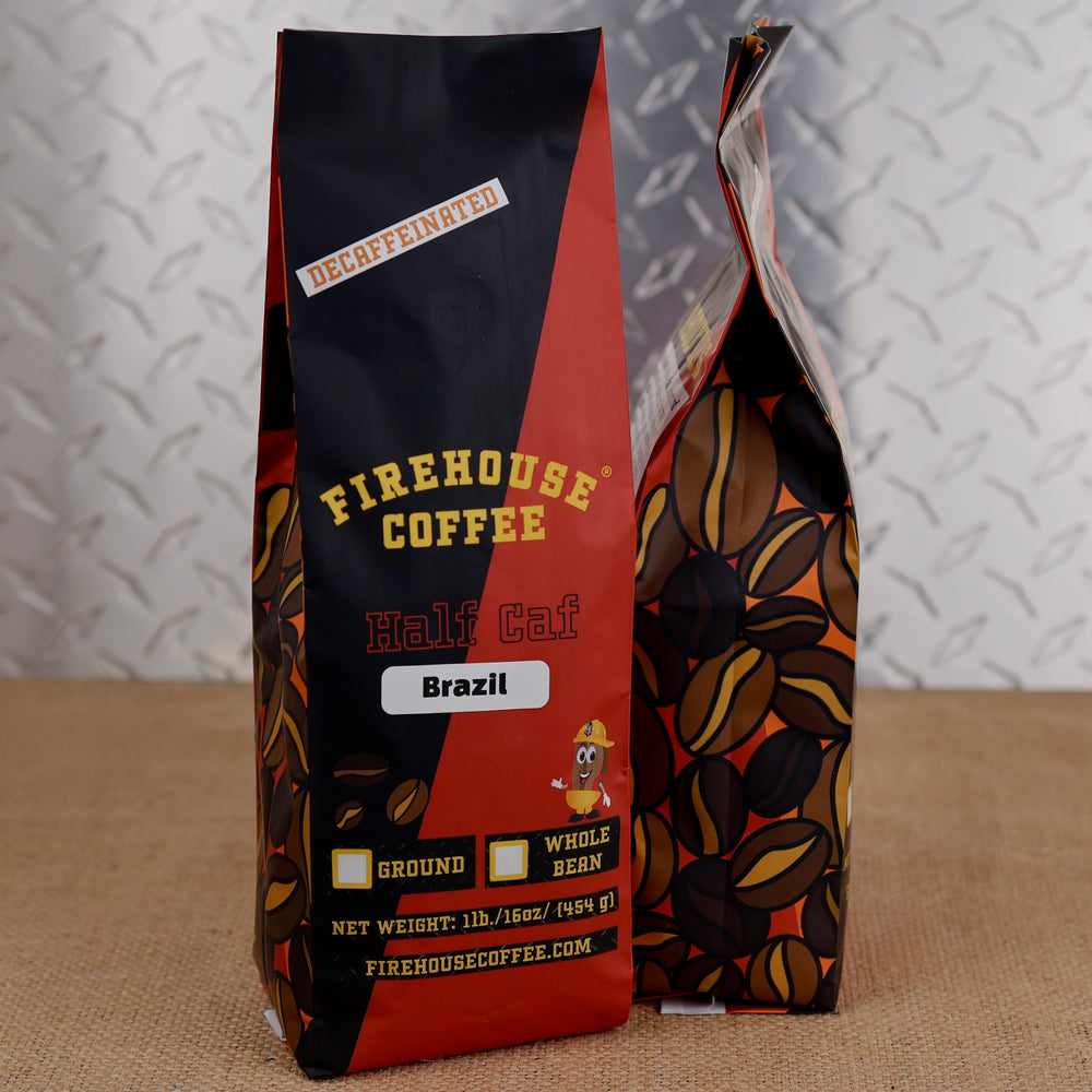 Firehouse Coffee Half Caf Brazil coffee in a 1 lb red and black bag with coffee bean illustrations and a firefighter bean character.