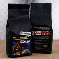 Two black coffee bags with boxing-themed labels on a textured surface.