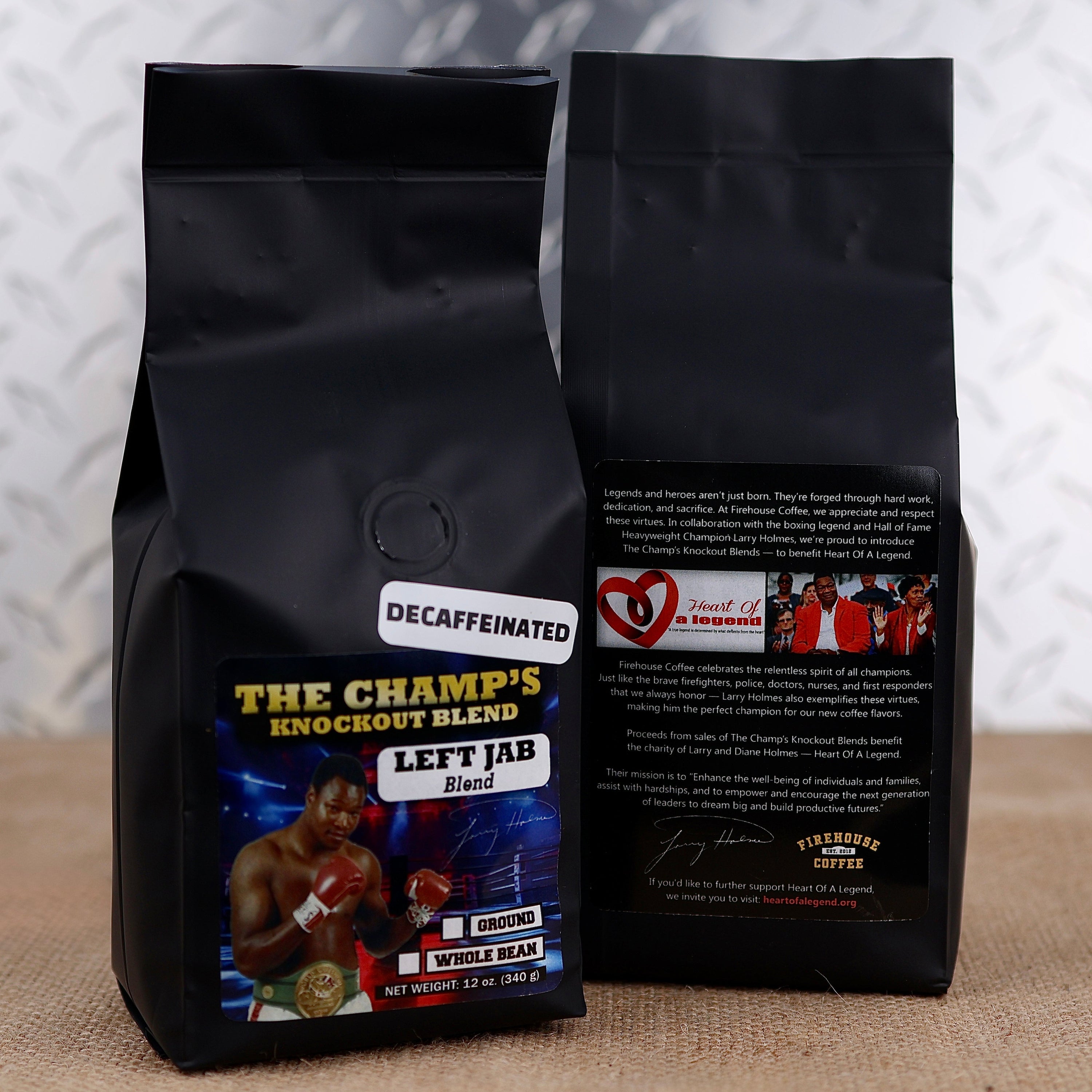 Two black coffee bags with boxing-themed labels on a textured surface.