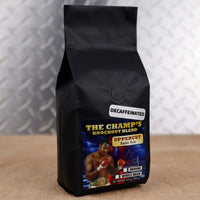 Firehouse Coffee Larry Holmes Left Jab Decaf Bourbon Pecan flavored coffee featuring boxing legend Larry Holmes on the label, available in whole bean or ground in a 12 oz bag.