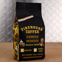 Firehouse Coffee Pumper Monkey Decaf Banana Foster flavored coffee in a 12 oz bag featuring rich banana, buttery caramel, cinnamon, and rum-inspired flavors. Freshly roasted decaffeinated coffee available in whole bean or ground.