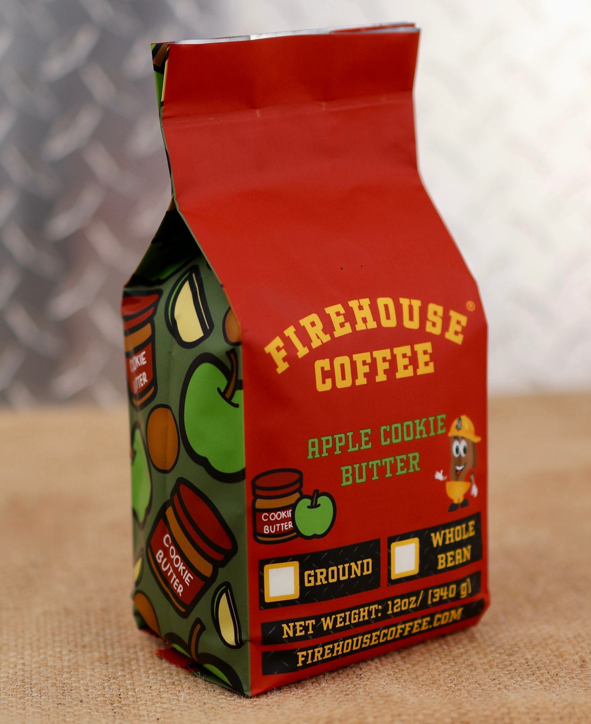 Firehouse Coffee Apple Cookie Butter packaging on a textured surface with a blurred background