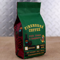 Firehouse Coffee Irish Cream & Raspberry flavored coffee in a 12 oz bag featuring rich Irish cream and sweet raspberry flavors. The package showcases Firehouse Coffee branding, raspberry graphics, and options for ground or whole bean coffee.