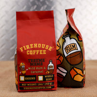 Firehouse Coffee Trauma Mama Wild Rum & Caramel coffee bags displayed in red branded packaging, featuring tropical rum and caramel flavored coffee in whole bean and ground options