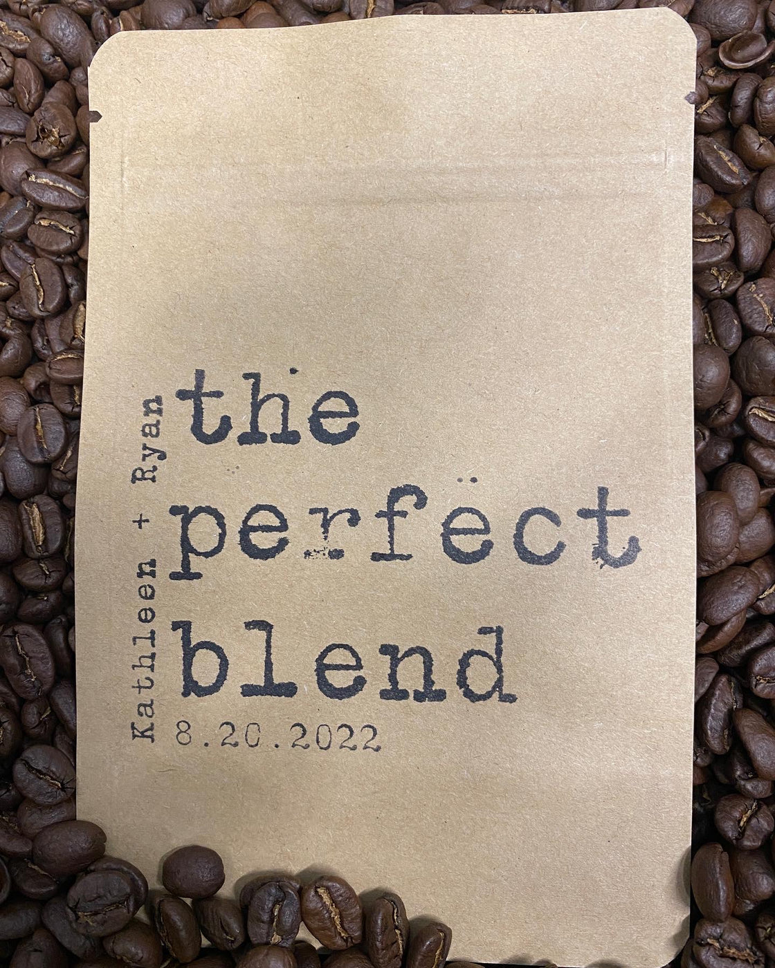 Actual Firehouse Coffee wedding favor bag with The Perfect Blend design, personalized names and wedding date, surrounded by coffee beans